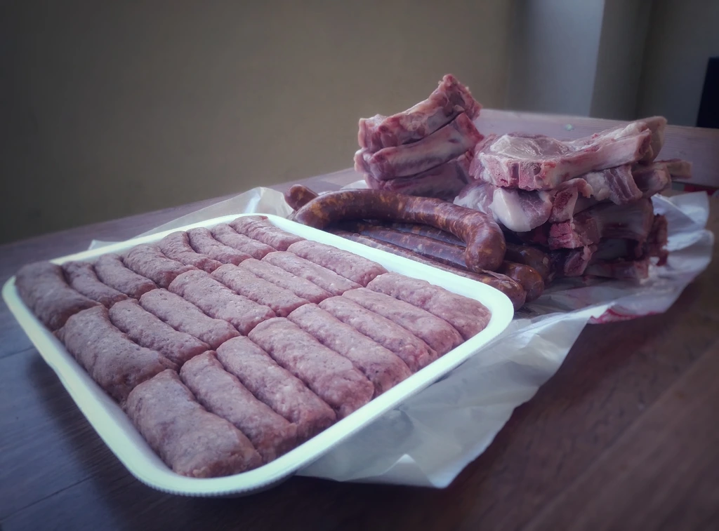 Various cuts of fresh meat laying on butcher paper.