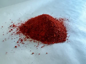 Cayenne Pepper powder laying on a baking paper surface.