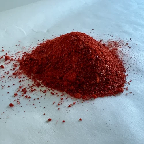 Cayenne Pepper powder laying on a baking paper surface.