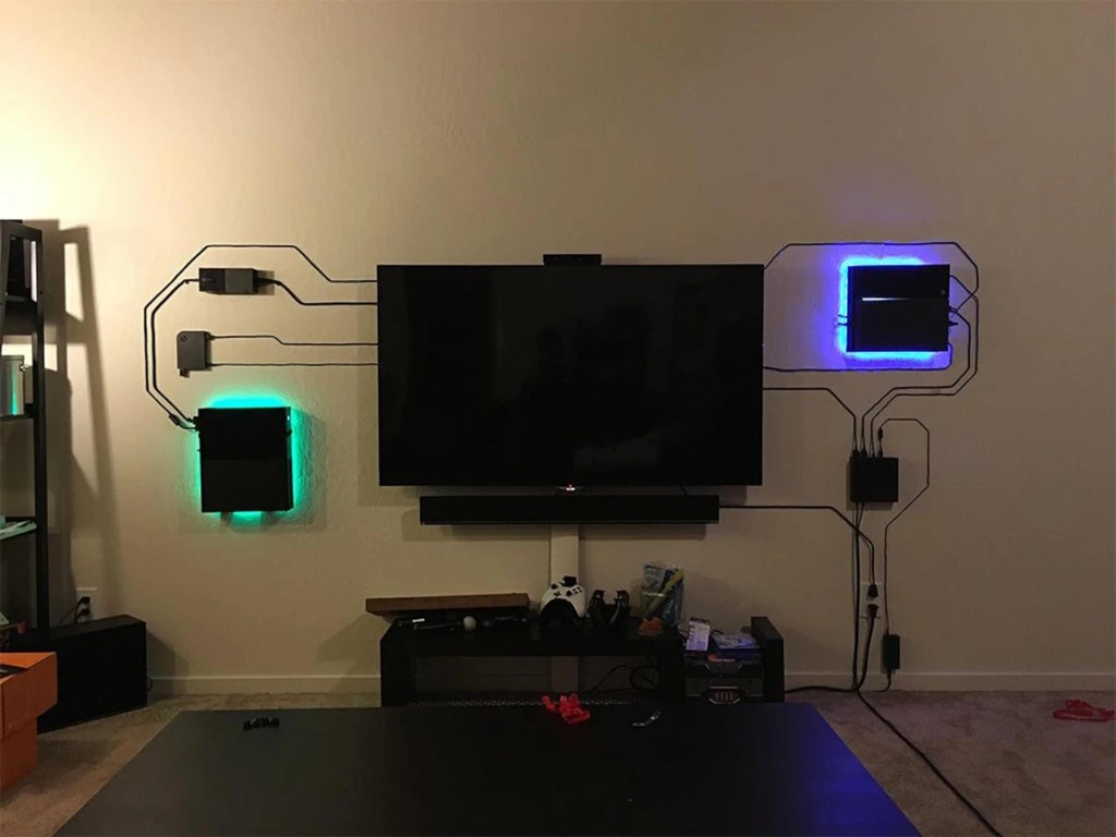 Image is showing a wall on which a TV and various home entertainment devices are mounted.